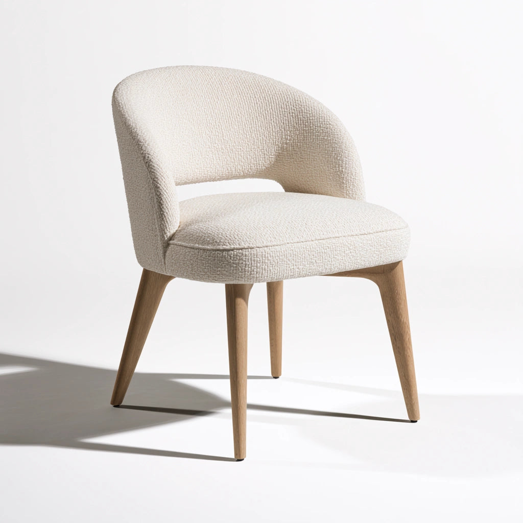 Modern gray Cavelyx dining chair with curved backrest and rounded seat, ideal for contemporary dining rooms.
