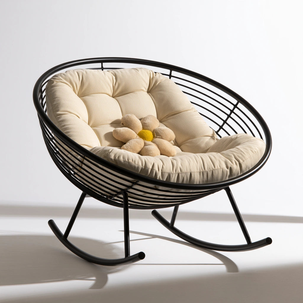 Modern black metal rocking chair with curved frame, designed for relaxation and stylish comfort.